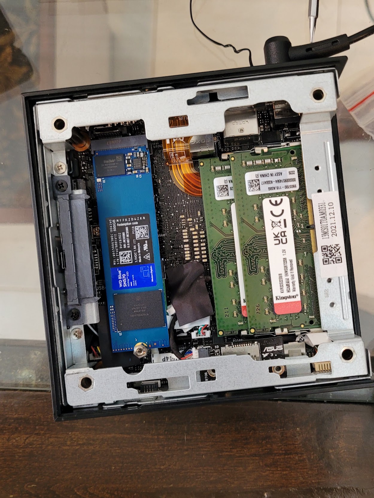 Inside the ASUS mini PC used for the benchmark, showing its two memory modules and NVMe drive