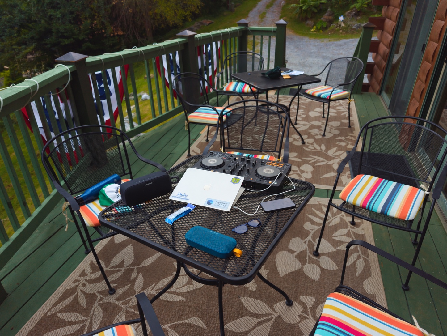 A DJ controller and laptop set up on a cabin deck